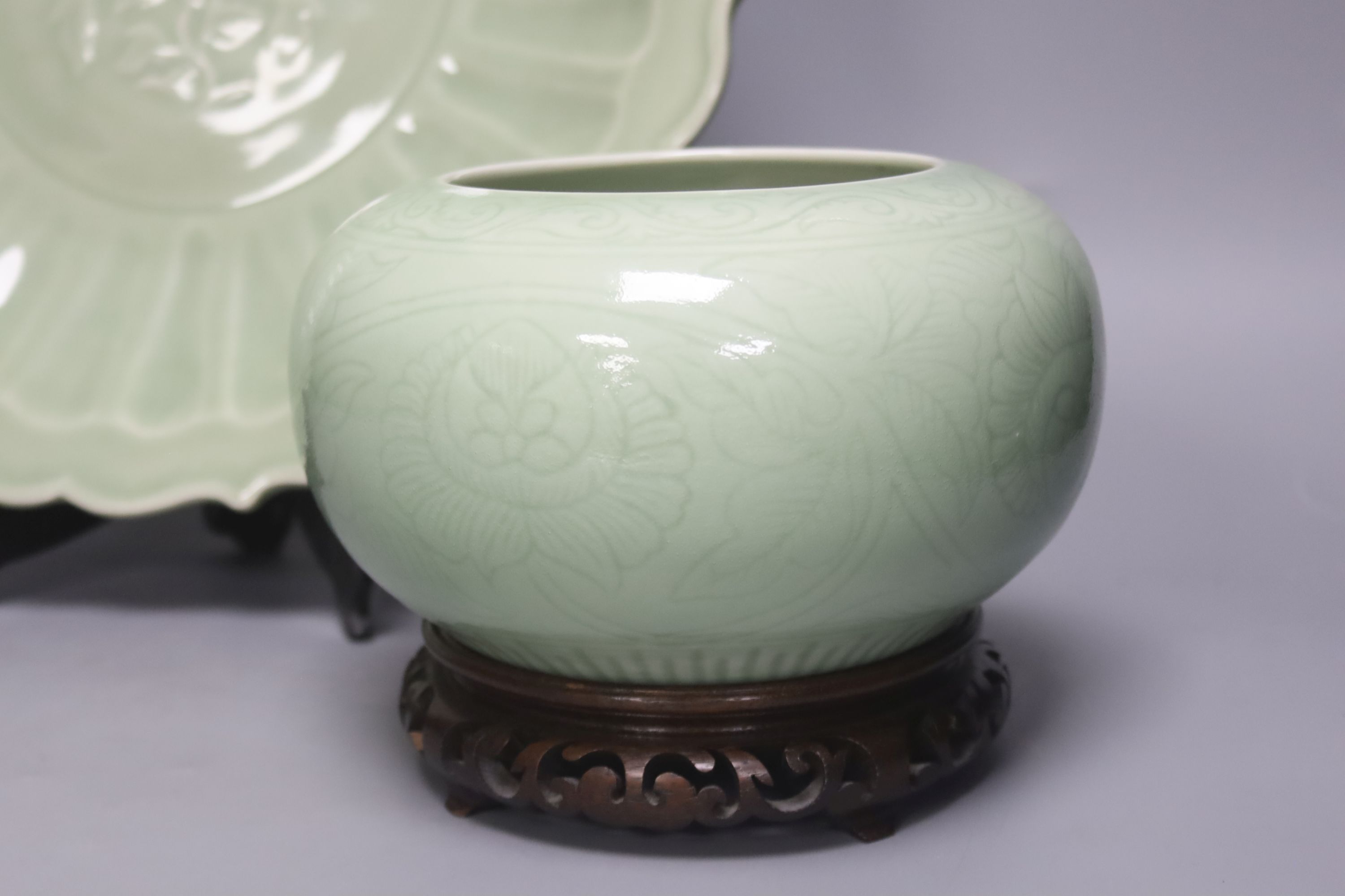 A Chinese circular celadon dish with scalloped rim, diameter 36cm, and a similar bowl, both with stands